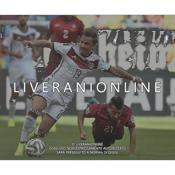 (140616) -- SALVADOR, June 16, 2014 () -- Germany\'s Mario Gotze (L) breaks through the defense of Portugal\'s Joao Pereira during a Group G match between Germany and Portugal of 2014 FIFA World Cup at the Arena Fonte Nova Stadium in Salvador, Brazil, June 16, 2014. (/Qi Heng)(pcy) AG ALDO LIVERANI SAS ONLY ITALY