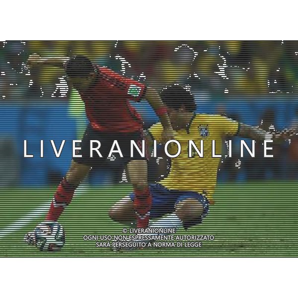(140617) -- FORTALEZA, June 17, 2014 () -- Brazil\'s Marcelo (R) vies with Mexico\'s Marco Fabian (L) during a Group A match between Brazil and Mexico of 2014 FIFA World Cup at the Estadio Castelao Stadium in Fortaleza, Brazil, June 17, 2014.The match concluded 0-0.(/Guo Yong)(rh) AG ALDO LIVERANI SAS ONLY ITALY