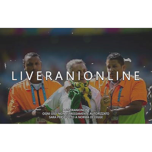 (140617) -- BELO HORIZONTE, June 17, 2014 () -- A fan (C) is escorted by the security guards as he jumped into the pitch prior to a Group H match between Belgium and Algeria of 2014 FIFA World Cup at the Estadio Mineirao Stadium in Belo Horizonte, Brazil, June 17, 2014.(/Liu Bin)(xzj) AG ALDO LIVERANI SAS ONLY ITALY