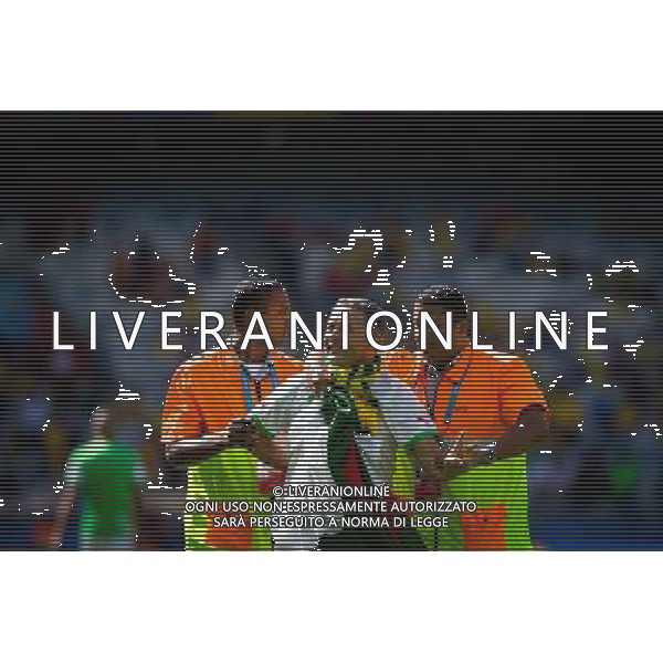 (140617) -- BELO HORIZONTE, June 17, 2014 () -- A fan (C) is escorted by the security guards as he jumped into the pitch prior to a Group H match between Belgium and Algeria of 2014 FIFA World Cup at the Estadio Mineirao Stadium in Belo Horizonte, Brazil, June 17, 2014.(/Liu Bin)(xzj) AG ALDO LIVERANI SAS ONLY ITALY