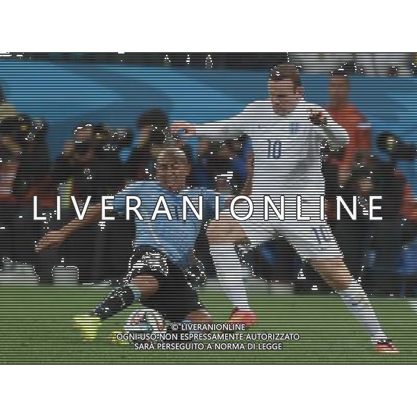 (140619) -- SAO PAULO, June 19, 2014 () -- Uruguay\'s Egidio Arevalo Rios (L) vies with England\'s Wayne Rooney during a Group D match between Uruguay and England of 2014 FIFA World Cup at the Arena de Sao Paulo Stadium in Sao Paulo, Brazil, June 19, 2014.Uruguay won 2-1 over England on Thursday.(/Li Ga)(pcy) 2014 FIFA World Cup Brazil Group D match between Uruguay and England at Arena de Sao Paulo on June 19, 2014 in Sao Paulo, Brazil. ©photoshot/Agenzia Aldo Liverani sas - ITALY ONLY - EDITORIAL USE ONLY