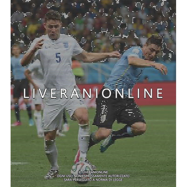 (140619) -- SAO PAULO, June 19, 2014 () -- England\'s Gary Cahill (L) vies with Uruguay\'s Cristian Rodriguez during a Group D match between Uruguay and England of 2014 FIFA World Cup at the Arena de Sao Paulo Stadium in Sao Paulo, Brazil, June 19, 2014.Uruguay won 2-1 over England on Thursday.(/Li Ga)(pcy) 2014 FIFA World Cup Brazil Group D match between Uruguay and England at Arena de Sao Paulo on June 19, 2014 in Sao Paulo, Brazil. ©photoshot/Agenzia Aldo Liverani sas - ITALY ONLY - EDITORIAL USE ONLY