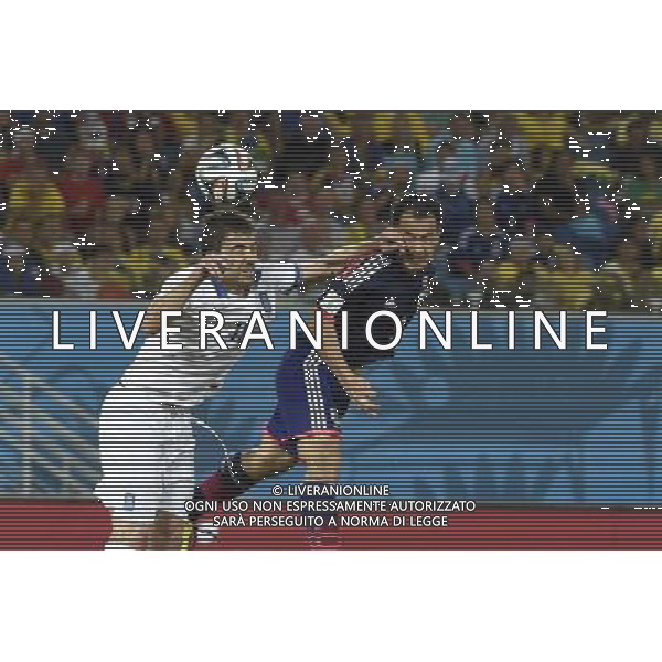 (140619) -- NATAL, June 19, 2014 () -- Greece\'s Sokratis Papastathopoulos (L) competes for a header with Japan\'s Shinji Okazaki during a Group C match between Japan and Greece of 2014 FIFA World Cup at the Estadio das Dunas Stadium in Natal, Brazil, June 19, 2014. (/Lui Siu Wai)(xzj) ©photoshot/Agenzia Aldo Liverani sas - ITALY ONLY - EDITORIAL USE ONLY