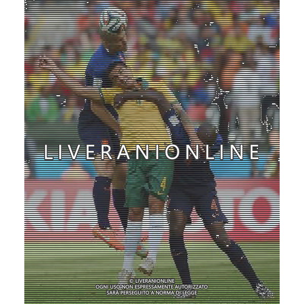 (140618) -- PORTO ALEGRE, June 18, 2014 () -- Australia\'s Tim Cahill (C) competes for a header with Netherlands\' Bruno Martins Indi (R) and Ron Vlaar (L) during a Group B match between Australia and Netherlands of 2014 FIFA World Cup at the Estadio Beira-Rio Stadium in Porto Alegre, Brazil, June 18, 2014.Netherlands won 3-2 over Australia on Wednesday.(/Li Ga)(pcy) ©photoshot/Agenzia Aldo Liverani sas - ITALY ONLY - EDITORIAL USE ONLY