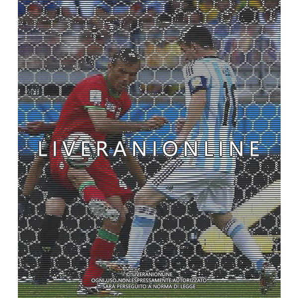 (140621) -- BELO HORIZONTE, June 21, 2014 () -- Jalal Hosseini (L) of Iran vies with Lionel Messi of Argentina during a Group F match between Argentina and Iran of 2014 FIFA World Cup at the Estadio Mineirao Stadium in Belo Horizonte, Brazil, June 21, 2014. (/Liu Bin)(zc) ©PHOTOSHOT/AGENZIA ALDO LIVERANI SAS - ITALY ONLY - EDITORIAL USE ONLY - ARGENTINA Vs IRAN partita del gruppo di F Coppa del mondo FIFA 2014 Mineirao stadio Estadio a Belo Horizonte, in Brasile, 21 giugno 2014