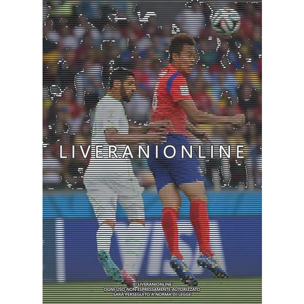 (140622) -- PORTO ALEGRE, June 22, 2014 () -- Rafik Halliche (L) of Algeria fights for the header with Kim Shin Wook of Korea Republic during a Group H match between Korea Republic and Algeria of 2014 FIFA World Cup at the Estadio Beira-Rio Stadium in Porto Alegre, Brazil, June 22, 2014. Algeria beat Korea Republic 4-2. (/Li Ga)(zc) ©PHOTOSHOT/Agenzia Aldo Liverani sas - ITALY ONLY - EDITORIAL USE ONLY