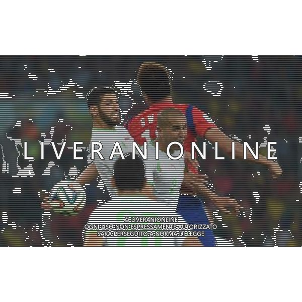 (140622) -- PORTO ALEGRE, June 22, 2014 () -- Rafik Halliche (1st L) of Algeria fights for the header during a Group H match between Korea Republic and Algeria of 2014 FIFA World Cup at the Estadio Beira-Rio Stadium in Porto Alegre, Brazil, June 22, 2014. Algeria beat Korea Republic 4-2. (/Li Ga)(zc) ©PHOTOSHOT/Agenzia Aldo Liverani sas - ITALY ONLY - EDITORIAL USE ONLY