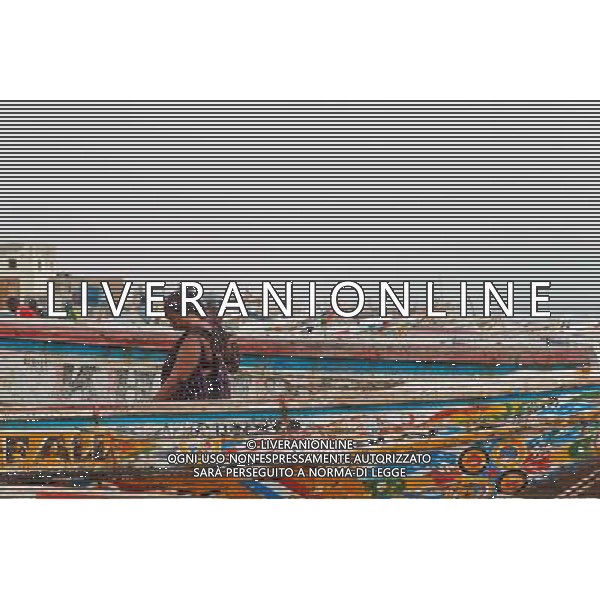 (140623) -- NOUAKCHOTT, June 23, 2014 () -- A woman walks through the boats at a fish market in Nouakchott, capital of Mauritania, June 22, 2014. (/Li Jing) (zjl) ©PHOTOSHOT/Agenzia Aldo Liverani sas - ITALY ONLY - EDITORIAL USE ONLY - Vita quotidiana della popolazione a Nouakchott, capitale della Mauritania, 22 giugno 2014