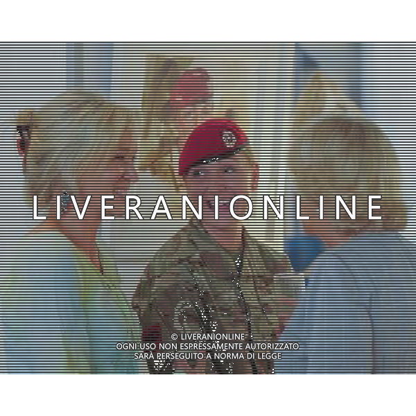 London, UK, 24/06/2014 : THE DUCHESS OF CORNWALL VISITS THE \'VOICES FROM THE DESERT\' EXHIBITION. The Duchess of Cornwall, Patron, Desert Rats Association, visits \'Voices from the Desert\', a Desert Rats exhibition by the artist Anna Redwood. The Duchess is pictured with Corporal Chelsea Williams whose portrait may be seen behind.. Picture by Julie Edwards ©PHOTOSHOT/Agenzia Aldo Liverani sas - ITALY ONLY - EDITORIAL USE ONLY - REALI INGLESI: Camilla duchessa di Cornovaglia in visita alla mostra \'Voci dal deserto\' dell\'artista Anna Redwood