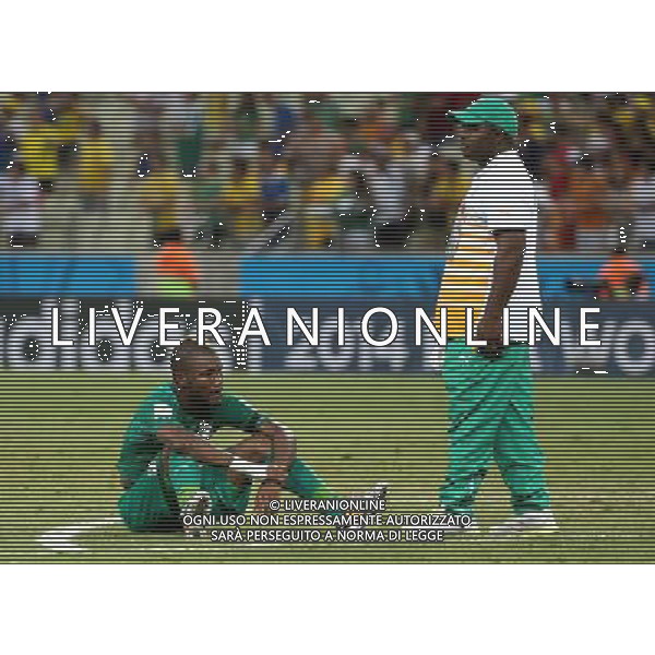 (140624) -- FORTALEZA, June 24, 2014 () -- Cote d\'Ivoire\'s Geoffroy Serey Die (L) sits on the ground after a Group C match between Greece and Cote d\'Ivoire of 2014 FIFA World Cup at the Estadio Castelao Stadium in Fortaleza, Brazil, June 24, 2014. Greece won 2-1 over Cote d\'Ivoire on Tuesday. (/Cao Can)(xzj) AG ALDO LIVERANI SAS ONLY ITALY