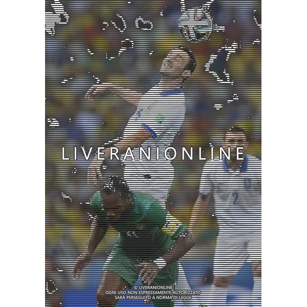 (140624) -- FORTALEZA, June 24, 2014 () -- Greece\'s Vasilis Torosidis (top) competes for a header with Cote d\'Ivoire\'s Didier Drogba during a Group C match between Greece and Cote d\'Ivoire of 2014 FIFA World Cup at the Estadio Castelao Stadium in Fortaleza, Brazil, June 24, 2014. (/Yang Lei)(xzj) AG ALDO LIVERANI SAS ONLY ITALY