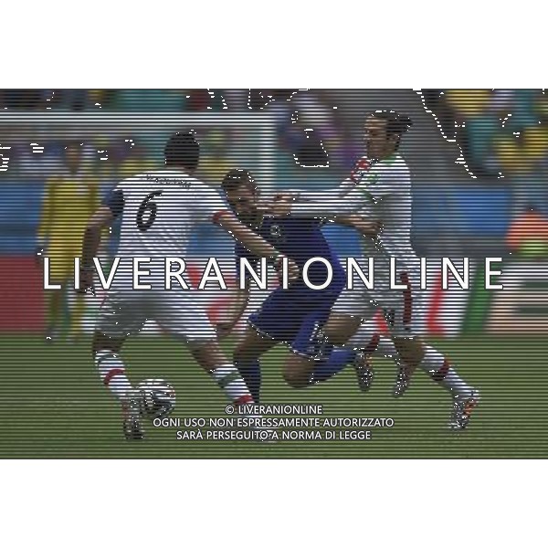 (140625) -- SALVADOR, June 25, 2014 () -- Bosnia And Herzegovina\'s Tino Susic (C) vies with Iran\'s Javad Nekounam (L) during a Group F match between Bosnia And Herzegovina and Iran of 2014 FIFA World Cup at the Arena Fonte Nova Stadium in Salvador, Brazil, June 24, 2014. (/Yang Lei) AG ALDO LIVERANI SAS ONLY ITALY