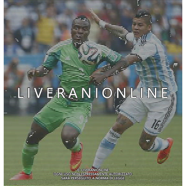 (140625) -- PORTO ALEGRE, June 25, 2014 () -- Argentina\'s Marcos Rojo (R) vies with Nigeria\'s Emmanuel Emenike during a Group F match between Nigeria and Argentina of 2014 FIFA World Cup at the Estadio Beira-Rio Stadium in Porto Alegre, Brazil, on June 25, 2014.(/Chen Jianli)(pcy) AG ALDO LIVERANI SAS ONLY ITALY