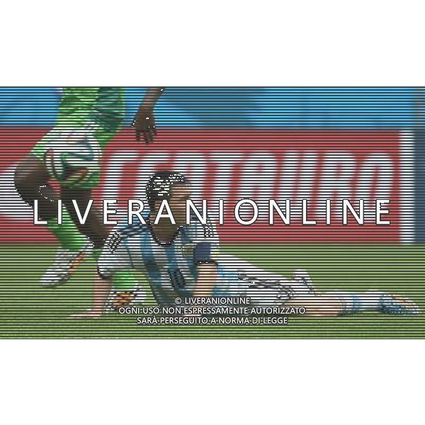 (140625) -- PORTO ALEGRE, June 25, 2014 () -- Argentina\'s Lionel Messi (R) falls down in a competition during a Group F match between Nigeria and Argentina of 2014 FIFA World Cup at the Estadio Beira-Rio Stadium in Porto Alegre, Brazil, on June 25, 2014.(/Li Ga)(pcy) AG ALDO LIVERANI SAS ONLY ITALY