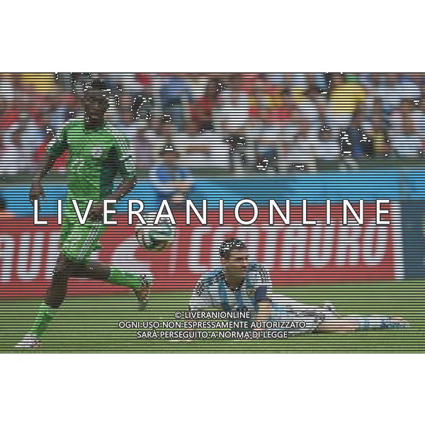 (140625) -- PORTO ALEGRE, June 25, 2014 () -- Argentina\'s Lionel Messi (R) falls down in a competition during a Group F match between Nigeria and Argentina of 2014 FIFA World Cup at the Estadio Beira-Rio Stadium in Porto Alegre, Brazil, on June 25, 2014.(/Li Ga)(pcy) AG ALDO LIVERANI SAS ONLY ITALY