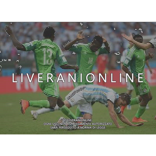 (140625) -- PORTO ALEGRE, June 25, 2014 () -- Argentina\'s Federico Fernandez (bottom) falls down in a competition with Nigeria\'s players during a Group F match between Nigeria and Argentina of 2014 FIFA World Cup at the Estadio Beira-Rio Stadium in Porto Alegre, Brazil, on June 25, 2014.(/Li Ga)(pcy) AG ALDO LIVERANI SAS ONLY ITALY
