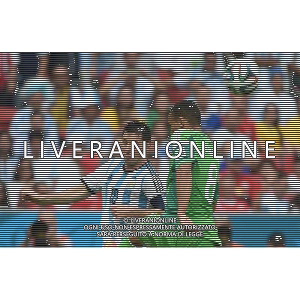 (140625) -- PORTO ALEGRE, June 25, 2014 () -- Argentina\'s Lionel Messi (L) competes with Nigeria\'s Peter Osaze Odemwingie during a Group F match between Nigeria and Argentina of 2014 FIFA World Cup at the Estadio Beira-Rio Stadium in Porto Alegre, Brazil, on June 25, 2014. Argentina won 3-2 over Nigeria on Wednesday. (/Li Ga)(pcy) AG ALDO LIVERANI SAS ONLY ITALY