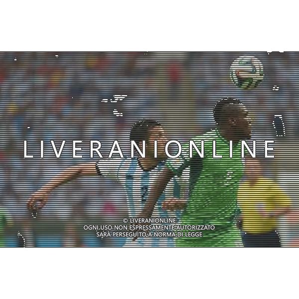 (140625) -- PORTO ALEGRE, June 25, 2014 () -- Argentina\'s Ezequiel Garay (L) vies with Nigeria\'s Emmanuel Emenike during a Group F match between Nigeria and Argentina of 2014 FIFA World Cup at the Estadio Beira-Rio Stadium in Porto Alegre, Brazil, on June 25, 2014. Argentina won 3-2 over Nigeria on Wednesday. (/Li Ga)(pcy) AG ALDO LIVERANI SAS ONLY ITALY