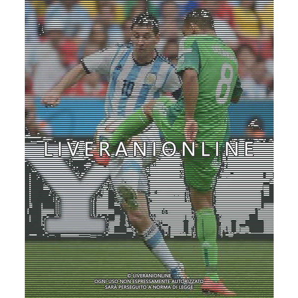 (140625) -- PORTO ALEGRE, June 25, 2014 () -- Argentina\'s Lionel Messi (L) vies with Nigeria\'s Peter Osaze Odemwingie during a Group F match between Nigeria and Argentina of 2014 FIFA World Cup at the Estadio Beira-Rio Stadium in Porto Alegre, Brazil, on June 25, 2014. Argentina won 3-2 over Nigeria on Wednesday. (/Li Ga)(pcy) AG ALDO LIVERANI SAS ONLY ITALY