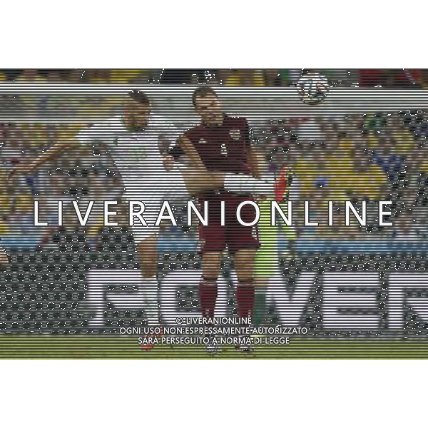 (140626) -- CURITIBA, June 26, 2014 () -- Algeria\'s Islam Slimani vies with Russia\'s Sergey Ignashevich during a Group H match between Algeria and Russia of 2014 FIFA World Cup at the Arena da Baixada Stadium in Curitiba, Brazil, June 26, 2014. The match ended in a 1-1 draw.Algeria enters Round of 16 after the Thursday match which ended in a 1-1 draw.(/Liao Yujie) ©PHOTOHOT/Agenzia Aldo Liverani sas - ITALY ONLY - EDITORIAL USE ONLY