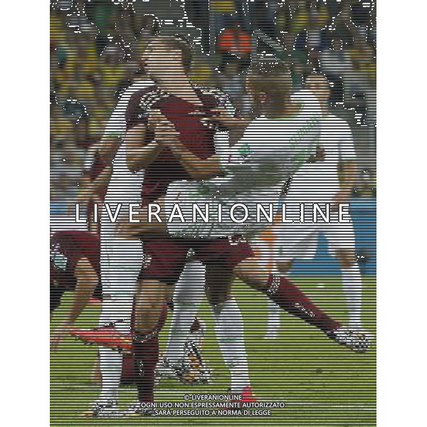 (140626) -- CURITIBA, June 26, 2014 () -- Algeria\'s Islam Slimani vies with Russia\'s Dmitriy Kombarov during a Group H match between Algeria and Russia of 2014 FIFA World Cup at the Arena da Baixada Stadium in Curitiba, Brazil, June 26, 2014. (/Zhou Lei) ©PHOTOHOT/Agenzia Aldo Liverani sas - ITALY ONLY - EDITORIAL USE ONLY