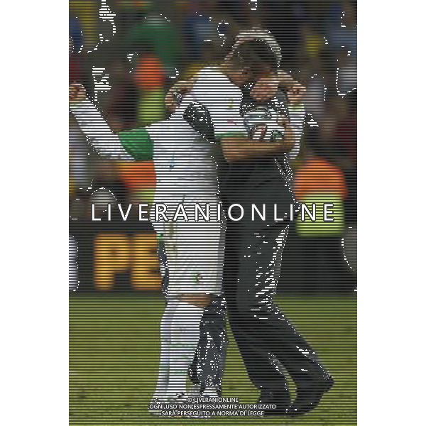 (140626) -- CURITIBA, June 26, 2014 () -- Algeria\'s coach Vahid Halilhodzic (R) hugs Esseid Belkalem after a Group H match between Algeria and Russia of 2014 FIFA World Cup at the Arena da Baixada Stadium in Curitiba, Brazil, June 26, 2014. The match ended in a 1-1 draw.(/Zhou Lei) ©PHOTOHOT/Agenzia Aldo Liverani sas - ITALY ONLY - EDITORIAL USE ONLY