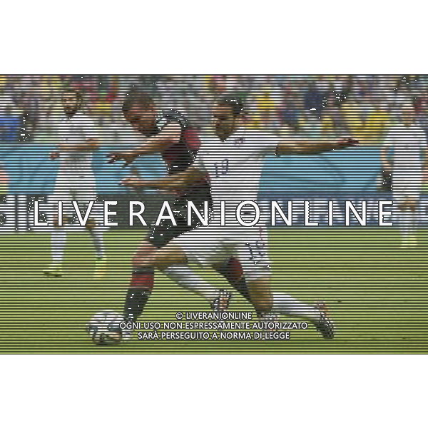 (140626) -- RECIFE, June 26, 2014 () -- Germany\'s Lukas Podolski (L, front) vies with Graham Zusi of the U.S. (R, front) during a Group G match between the U.S. and Germany of 2014 FIFA World Cup at the Arena Pernambuco Stadium in Recife, Brazil, on June 26, 2014.(/Lui Siu Wai)(pcy) ©PHOTOHOT/Agenzia Aldo Liverani sas - ITALY ONLY - EDITORIAL USE ONLY