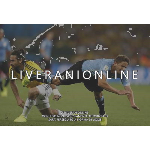 (140628) -- RIO DE JANEIRO, June 28, 2014 () -- Uruguay\'s Gaston Ramirez (R) falls down during a Round of 16 match between Colombia and Uruguay of 2014 FIFA World Cup at the Estadio do Maracana Stadium in Rio de Janeiro, Brazil, on June 28, 2014. Colombia won 2-0 over Uruguay and qualified for Quarter-finals on Saturday.(/Wang Lili)(pcy) AG ALDO LIVERANI SAS ONLY ITALY