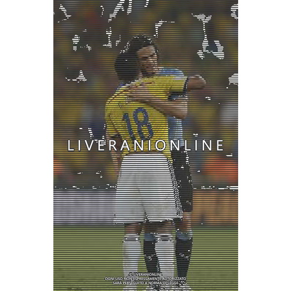 (140628) -- RIO DE JANEIRO, June 28, 2014 () -- Colombia\'s Juan Zuniga (front) embraces Uruguay\'s Edinson Cavani after a Round of 16 match between Colombia and Uruguay of 2014 FIFA World Cup at the Estadio do Maracana Stadium in Rio de Janeiro, Brazil, on June 28, 2014. Colombia won 2-0 over Uruguay and qualified for Quarter-finals on Saturday.(/Wang Lili)(pcy) AG ALDO LIVERANI SAS ONLY ITALY