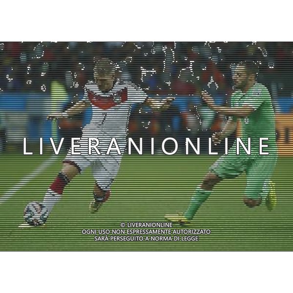 (140630) -- PORTO ALEGRE, June 30, 2014 () -- Germany\'s Bastian Schweinsteiger vies with Algeria\'s Medhi Lacen during a Round of 16 match between Germany and Algeria of 2014 FIFA World Cup at the Estadio Beira-Rio Stadium in Porto Alegre, Brazil, on June 30, 2014. (/Chen Jianli)(rh) ©photoshot/Agenzia Aldo Liverani sas - ITALY ONLY - EDITORIAL USE ONLY - Germania Vs Algeria Coppa del Mondo FIFA World Cup presso l\'Estadio Stadio Beira-Rio di Porto Alegre, in Brasile, il 30 giugno 2014