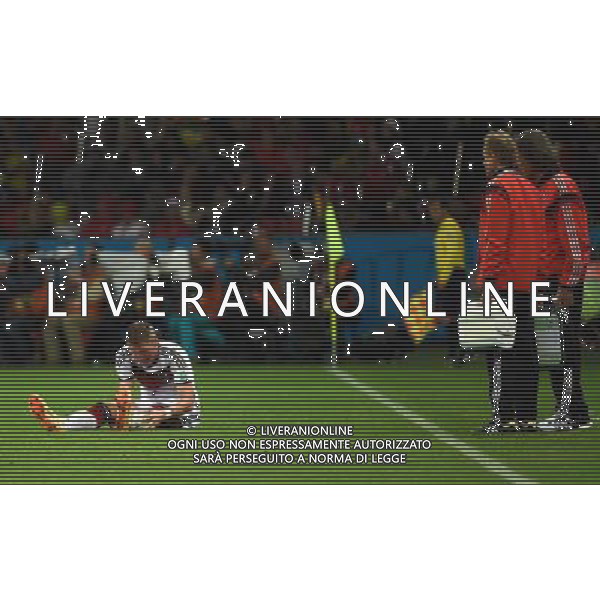 (140630) -- PORTO ALEGRE, June 30, 2014 () -- Germany\'s Bastian Schweinsteiger (L) falls down as being injured during a Round of 16 match between Germany and Algeria of 2014 FIFA World Cup at the Estadio Beira-Rio Stadium in Porto Alegre, Brazil, on June 30, 2014. (/Li Ga)(pcy) ©photoshot/Agenzia Aldo Liverani sas - ITALY ONLY - EDITORIAL USE ONLY - Germania Vs Algeria Coppa del Mondo FIFA World Cup presso l\'Estadio Stadio Beira-Rio di Porto Alegre, in Brasile, il 30 giugno 2014