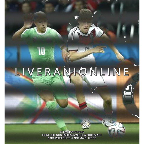 (140630) -- PORTO ALEGRE, June 30, 2014 () -- Germany\'s Thomas Muller vies with Algeria\'s Sofiane Feghouli during a Round of 16 match between Germany and Algeria of 2014 FIFA World Cup at the Estadio Beira-Rio Stadium in Porto Alegre, Brazil, on June 30, 2014. (/Chen Jianli)(rh) ©photoshot/Agenzia Aldo Liverani sas - ITALY ONLY - EDITORIAL USE ONLY - Germania Vs Algeria Coppa del Mondo FIFA World Cup presso l\'Estadio Stadio Beira-Rio di Porto Alegre, in Brasile, il 30 giugno 2014