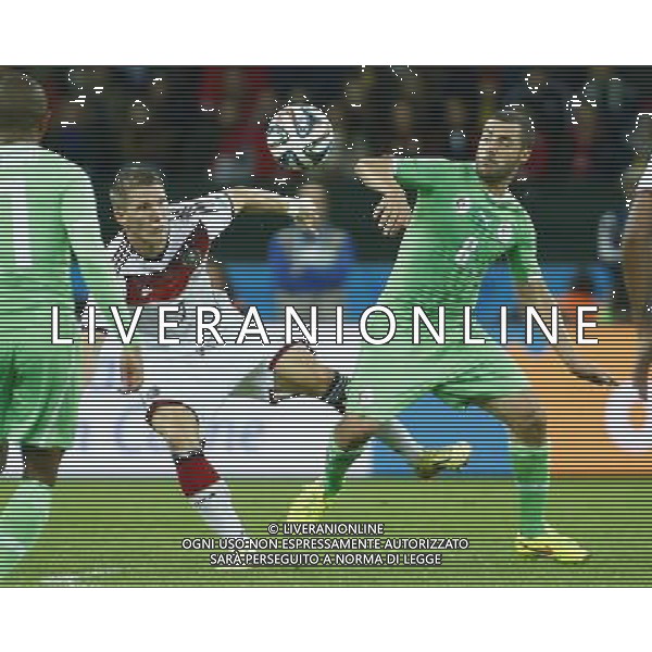 (140630) -- PORTO ALEGRE, June 30, 2014 () -- Germany\'s Bastian Schweinsteiger vies with Algeria\'s Medhi Lacen during a Round of 16 match between Germany and Algeria of 2014 FIFA World Cup at the Estadio Beira-Rio Stadium in Porto Alegre, Brazil, on June 30, 2014. (/Chen Jianli)(rh) ©photoshot/Agenzia Aldo Liverani sas - ITALY ONLY - EDITORIAL USE ONLY - Germania Vs Algeria Coppa del Mondo FIFA World Cup presso l\'Estadio Stadio Beira-Rio di Porto Alegre, in Brasile, il 30 giugno 2014