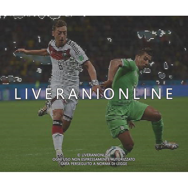 (140630) -- PORTO ALEGRE, June 30, 2014 () -- Algeria\'s Saphir Taider (R) vies with Germany\'s Mesut Ozil during a Round of 16 match between Germany and Algeria of 2014 FIFA World Cup at the Estadio Beira-Rio Stadium in Porto Alegre, Brazil, on June 30, 2014. (/Li Ga)(pcy) ©photoshot/Agenzia Aldo Liverani sas - ITALY ONLY - EDITORIAL USE ONLY - Germania Vs Algeria Coppa del Mondo FIFA World Cup presso l\'Estadio Stadio Beira-Rio di Porto Alegre, in Brasile, il 30 giugno 2014