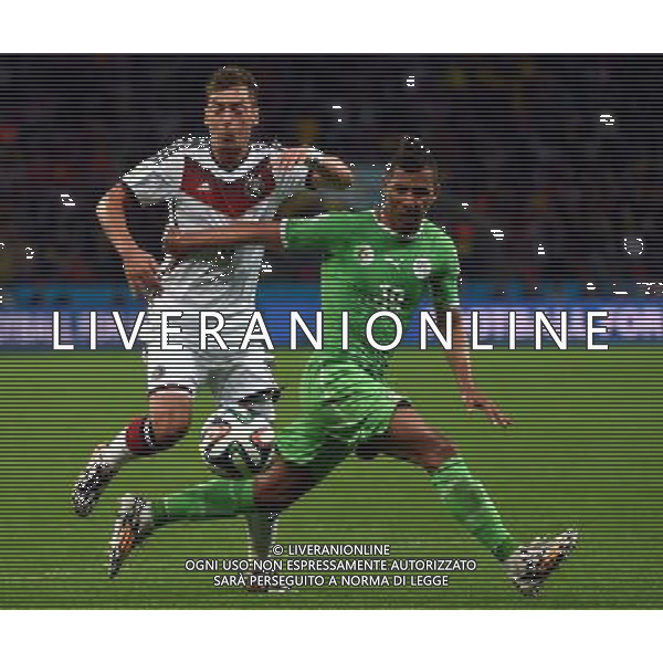 (140630) -- PORTO ALEGRE, June 30, 2014 () -- Algeria\'s Saphir Taider (R) vies with Germany\'s Mesut Ozil during a Round of 16 match between Germany and Algeria of 2014 FIFA World Cup at the Estadio Beira-Rio Stadium in Porto Alegre, Brazil, on June 30, 2014. (/Li Ga)(pcy) ©photoshot/Agenzia Aldo Liverani sas - ITALY ONLY - EDITORIAL USE ONLY - Germania Vs Algeria Coppa del Mondo FIFA World Cup presso l\'Estadio Stadio Beira-Rio di Porto Alegre, in Brasile, il 30 giugno 2014
