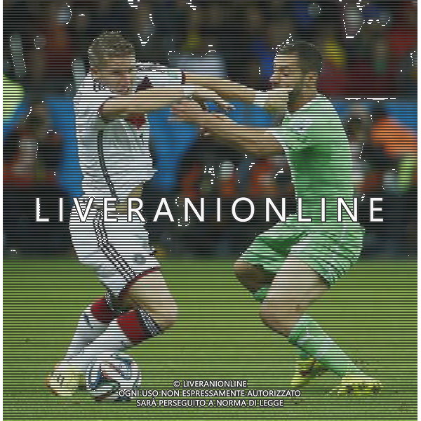 (140630) -- PORTO ALEGRE, June 30, 2014 () -- Germany\'s Bastian Schweinsteiger (L) vies for the ball during a Round of 16 match between Germany and Algeria of 2014 FIFA World Cup at the Estadio Beira-Rio Stadium in Porto Alegre, Brazil, on June 30, 2014. (/Chen Jianli)(rh) ©photoshot/Agenzia Aldo Liverani sas - ITALY ONLY - EDITORIAL USE ONLY - Germania Vs Algeria Coppa del Mondo FIFA World Cup presso l\'Estadio Stadio Beira-Rio di Porto Alegre, in Brasile, il 30 giugno 2014