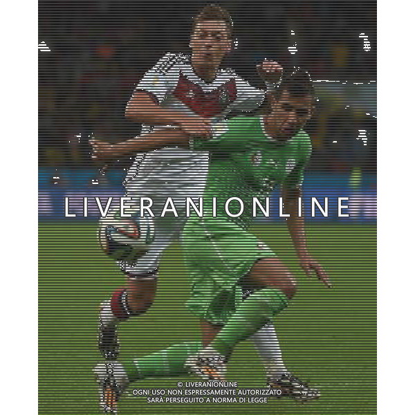 (140630) -- PORTO ALEGRE, June 30, 2014 () -- Algeria\'s Saphir Taider (R) vies with Germany\'s Mesut Ozil during a Round of 16 match between Germany and Algeria of 2014 FIFA World Cup at the Estadio Beira-Rio Stadium in Porto Alegre, Brazil, on June 30, 2014. (/Li Ga)(pcy) ©photoshot/Agenzia Aldo Liverani sas - ITALY ONLY - EDITORIAL USE ONLY - Germania Vs Algeria Coppa del Mondo FIFA World Cup presso l\'Estadio Stadio Beira-Rio di Porto Alegre, in Brasile, il 30 giugno 2014