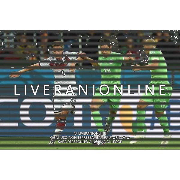 (140630) -- PORTO ALEGRE, June 30, 2014 () -- Algeria\'s Aissa Mandi (C) vies with Germany\'s Mesut Ozil (L) during a Round of 16 match between Germany and Algeria of 2014 FIFA World Cup at the Estadio Beira-Rio Stadium in Porto Alegre, Brazil, on June 30, 2014. (/Li Ga)(pcy) ©photoshot/Agenzia Aldo Liverani sas - ITALY ONLY - EDITORIAL USE ONLY - Germania Vs Algeria Coppa del Mondo FIFA World Cup presso l\'Estadio Stadio Beira-Rio di Porto Alegre, in Brasile, il 30 giugno 2014