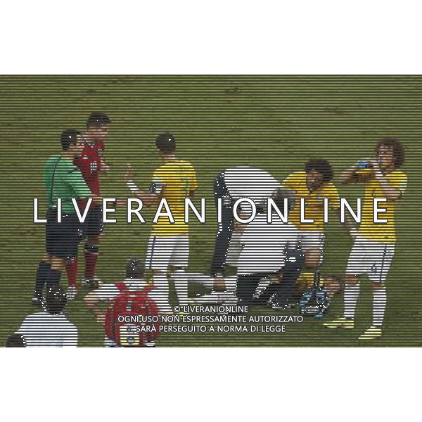 (140704) -- FORTALEZA, July 4, 2014 () -- Brazil\'s Neymar (bottom) falls down after being hit on the back during a quarter-finals match between Brazil and Colombia of 2014 FIFA World Cup at the Estadio Castelao Stadium in Fortaleza, Brazil, on July 4, 2014. Brazil won 2-1 over Colombia and qualified for semi-finals on Friday. (/Liao Yujie)(pcy) AG ALDO LIVERANI SAS ONLY ITALY