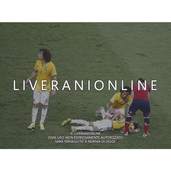 (140704) -- FORTALEZA, July 4, 2014 () -- Brazil\'s Neymar (bottom) falls down after being hit on the back during a quarter-finals match between Brazil and Colombia of 2014 FIFA World Cup at the Estadio Castelao Stadium in Fortaleza, Brazil, on July 4, 2014. Brazil won 2-1 over Colombia and qualified for semi-finals on Friday. (/Liao Yujie)(pcy) AG ALDO LIVERANI SAS ONLY ITALY