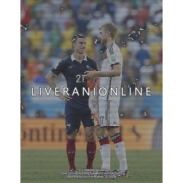 (140704) -- RIO DE JANEIRO, July 4, 2014 () -- France\'s Laurent Koscielny speaks with Germany\'s Per Mertesacker after a quarter-finals match between France and Germany of 2014 FIFA World Cup at the Estadio do Maracana Stadium in Rio de Janeiro, Brazil, on July 4, 2014. Germany won 1-0 over France and qualified for semi-finals on Friday.(/Wang Lili)(rh) AG ALDO LIVERANI SAS ONLY ITALY
