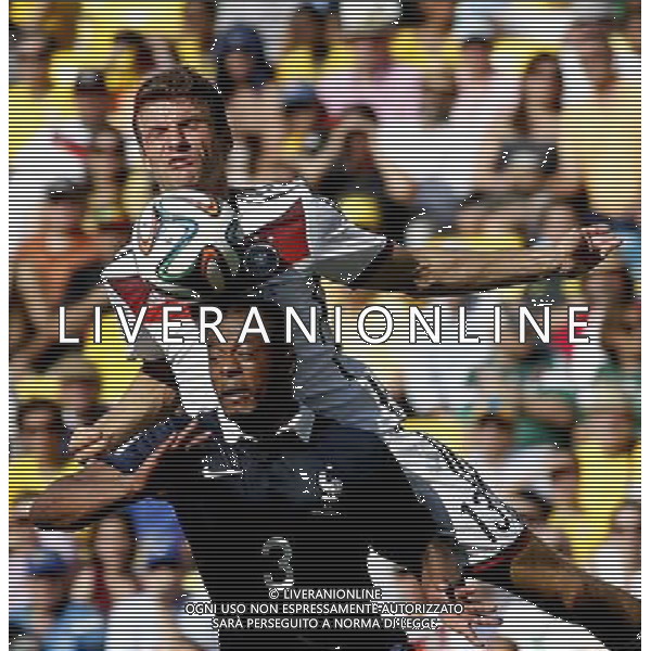 (140704) -- RIO DE JANEIRO, July 4, 2014 () -- Germany\'s Thomas Muller (up) vies with France\'s Patrice Evra during a quarter-finals match between France and Germany of 2014 FIFA World Cup at the Estadio do Maracana Stadium in Rio de Janeiro, Brazil, on July 4, 2014.(/Wang Lili)(pcy) AG ALDO LIVERANI SAS ONLY ITALY