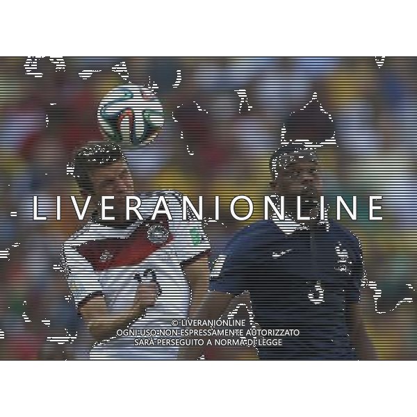 (140704) -- RIO DE JANEIRO, July 4, 2014 () -- Germany\'s Thomas Muller (L) competes for a header with France\'s Patrice Evra during a quarter-finals match between France and Germany of 2014 FIFA World Cup at the Estadio do Maracana Stadium in Rio de Janeiro, Brazil, on July 4, 2014.(/Wang Lili)(pcy) AG ALDO LIVERANI SAS ONLY ITALY