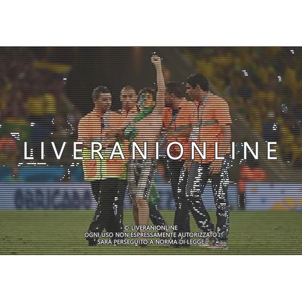 (140704) -- FORTALEZA, July 4, 2014 () -- Security members drag off a fan who runs into the field after a quarter-finals match between Brazil and Colombia of 2014 FIFA World Cup at the Estadio Castelao Stadium in Fortaleza, Brazil, on July 4, 2014. Brazil won 2-1 over Colombia and qualified for semi-finals on Friday. (/Li Ga)(pcy) AG ALDO LIVERANI SAS ONLY ITALY