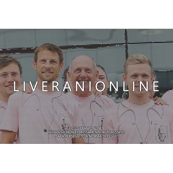 (L to R): Jenson Button (GBR) McLaren; Ron Dennis (GBR) McLaren Executive Chairman; Kevin Magnussen (DEN) McLaren; and the McLaren team wear Pink for Papa, in tribute to the late John Button (GBR). 06.07.2014. Formula 1 World Championship, Rd 9, British Grand Prix, Silverstone, England, Race Day. - www.xpbimages.com, EMail: requests@xpbimages.com - copy of publication required for printed pictures. Every used picture is fee-liable. © Copyright: Moy / XPB Images AG ALDO LIVERANI SAS ONLY ITALY