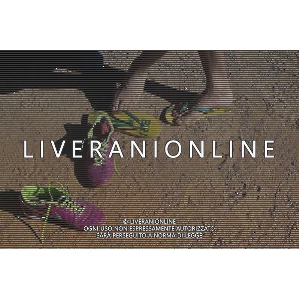 (140706) -- SAO PAULO, July 6, 2014 () -- A man changes his shoes before participating in a match of a \'Rebel Cup\' football tournament in downtown Sao Paulo, Brazil, July 6, 2014. According to the organizer, the \'Rebel Cup\' is an informal football tournament held to protest against the \'improper\' expenditure spent by government during the preparation of World Cup 2014. (/Rahel Patrasso)(xzj) ©PHOTOSHOT/Agenzia Aldo Liverani sas - ITALY ONLY - EDITORIAL USE ONLY - Torneo di calcio informale \'Rebel Cup\' coppa Ribelle nel centro di Sao Paulo, Brasile, 6 luglio 2014 per protestare contro le spese eccessive del governo per la Coppa del Mondo FIFA 2014