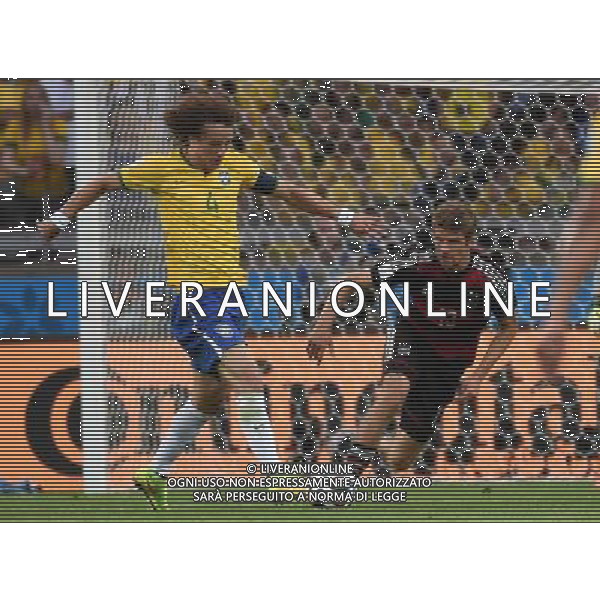(140708) -- BELO HORIZONTE, July 8, 2014 () -- Germany\'s Thomas Muller (R) vies with Brazil\'s David Luiz during a semifinal match between Brazil and Germany of 2014 FIFA World Cup at the Estadio Mineirao Stadium in Belo Horizonte, Brazil, on July 8, 2014. Germany won 7-1 over Brazil and qualified for the final on Tuesday. (/Li Ga)(pcy) ©photoshot/Agenzia Aldo Liverani sas - ITALY ONLY - EDITORIAL USE ONLY - BRASILE VS GERMANIA partita di semifinale Coppa del mondo FIFA 2014 Mineirao stadio Estadio a Belo Horizonte, in Brasile, 8 luglio 2014, la Germania ha vinto 7-1 e qualificato per la finale