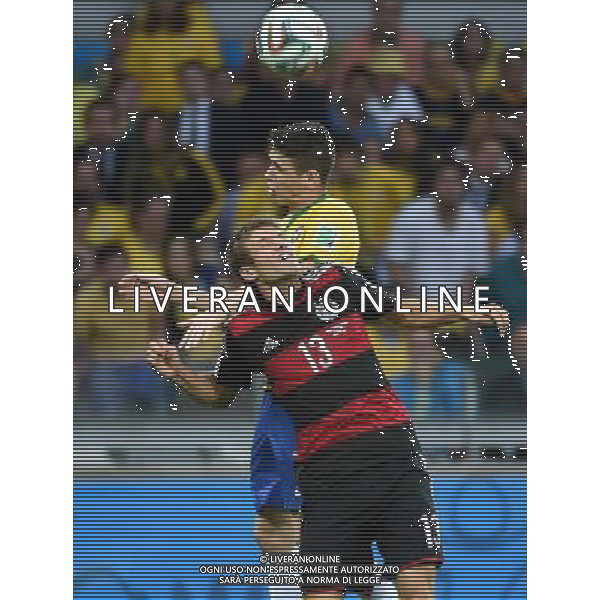 (140708) -- BELO HORIZONTE, July 8, 2014 () -- Germany\'s Thomas Muller (front) competes for a header with Brazil\'s Oscar (C) during a semifinal match between Brazil and Germany of 2014 FIFA World Cup at the Estadio Mineirao Stadium in Belo Horizonte, Brazil, on July 8, 2014. Germany won 7-1 over Brazil and qualified for the final on Tuesday. (/Li Ga)(pcy) ©photoshot/Agenzia Aldo Liverani sas - ITALY ONLY - EDITORIAL USE ONLY - BRASILE VS GERMANIA partita di semifinale Coppa del mondo FIFA 2014 Mineirao stadio Estadio a Belo Horizonte, in Brasile, 8 luglio 2014, la Germania ha vinto 7-1 e qualificato per la finale