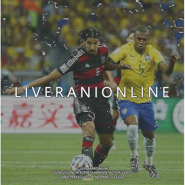 (140708) -- BELO HORIZONTE, July 8, 2014 () -- Germany\'s Sami Khedira (L) vies with Brazil\'s Fernandinho during a semifinal match between Brazil and Germany of 2014 FIFA World Cup at the Estadio Mineirao Stadium in Belo Horizonte, Brazil, on July 8, 2014. Germany won 7-1 over Brazil and qualified for the final on Tuesday. (/Chen Jianli)(pcy) ©PHOTOSHOT/Agenzia Aldo Liverani sas - ITALY ONLY - EDITORIAL USE ONLY - BRASILE VS GERMANIA partita di semifinale Coppa del mondo FIFA 2014 Mineirao stadio Estadio a Belo Horizonte, in Brasile, 8 luglio 2014, la Germania ha vinto 7-1 e qualificato per la finale