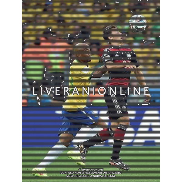 (140708) -- BELO HORIZONTE, July 8, 2014 () -- Brazil\'s Paulinho (L) vies with Germany\'s Mesut Ozil during a semifinal match between Brazil and Germany of 2014 FIFA World Cup at the Estadio Mineirao Stadium in Belo Horizonte, Brazil, on July 8, 2014. Germany won 7-1 over Brazil and qualified for the final on Tuesday. (/Liu Dawei)(pcy) ©PHOTOSHOT/Agenzia Aldo Liverani sas - ITALY ONLY - EDITORIAL USE ONLY - BRASILE VS GERMANIA partita di semifinale Coppa del mondo FIFA 2014 Mineirao stadio Estadio a Belo Horizonte, in Brasile, 8 luglio 2014, la Germania ha vinto 7-1 e qualificato per la finale